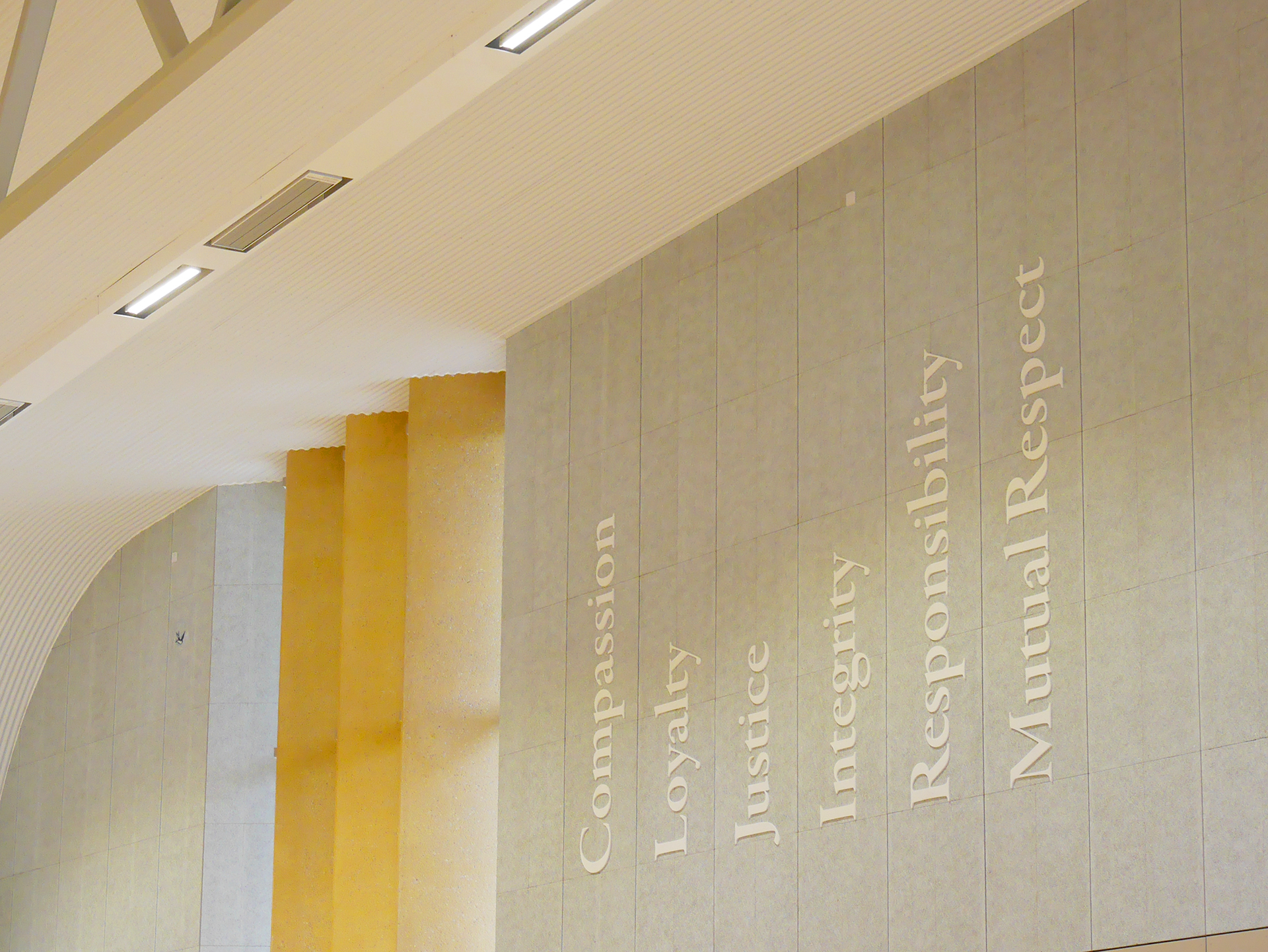 Interior wall of Mercedes College featuring core values engraved in large lettering: Compassion, Loyalty, Justice, Integrity, Responsibility, and Mutual Respect.