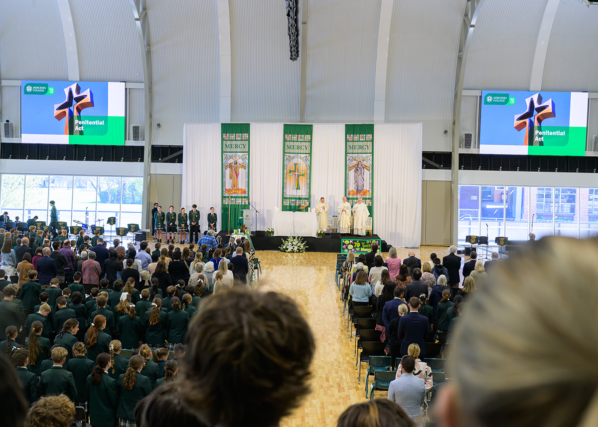 School-wide religious gathering at Mercedes College, with priests leading a service and students in formal uniform participating.